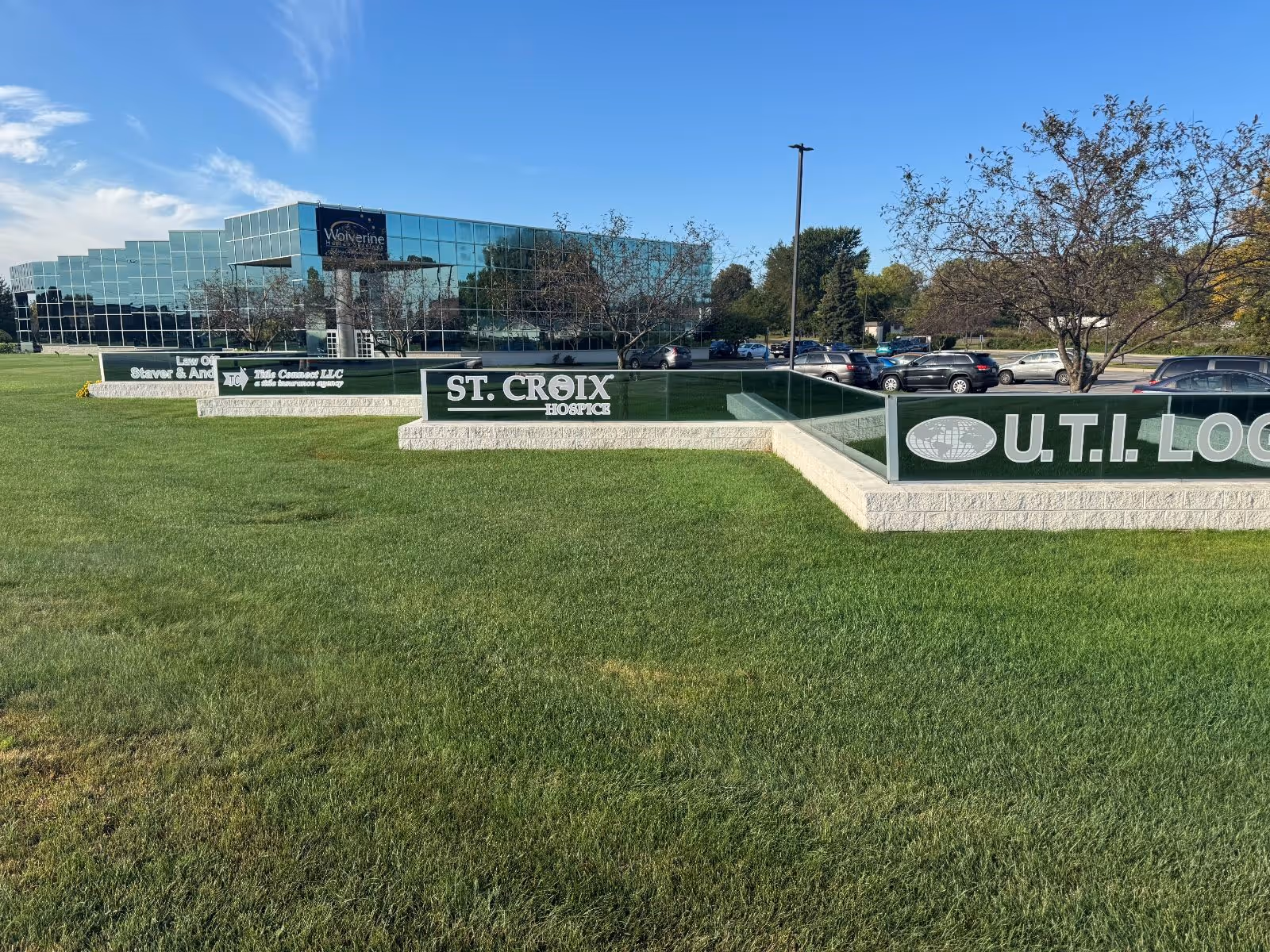 Glass-fronted building with St. Croix Hospice signage and a manicured lawn in the foreground.