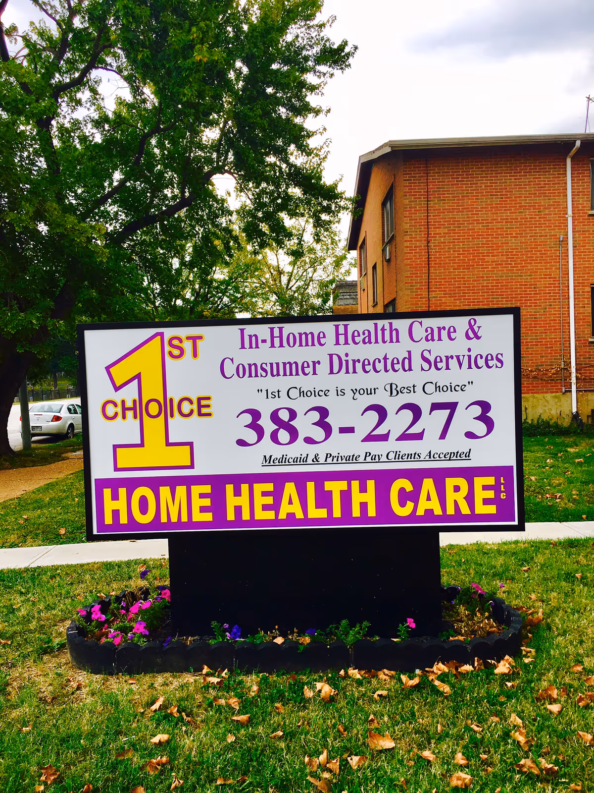 Outdoor sign for 1st Choice Home Health Care in front of brick building