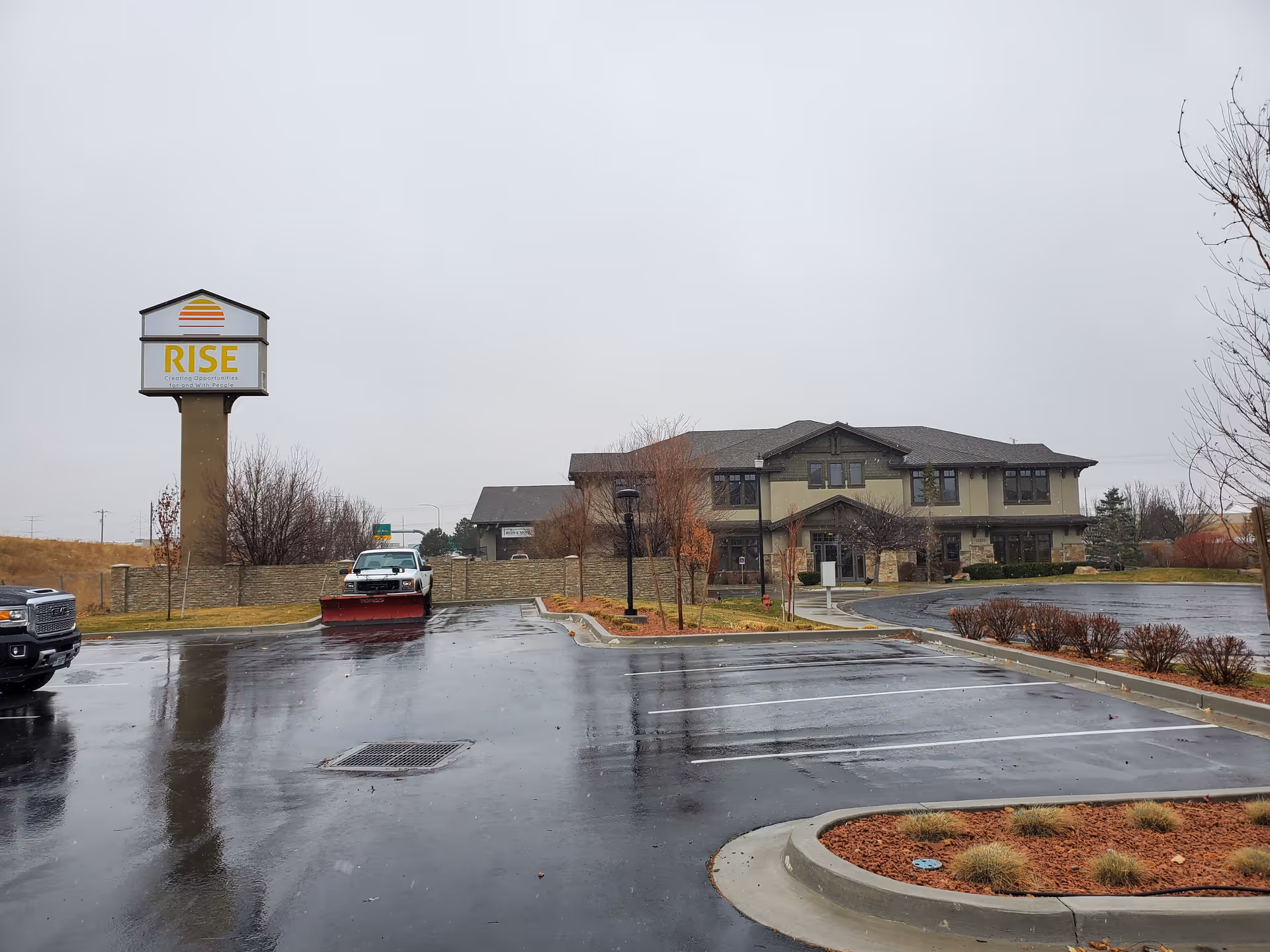 Exterior view of a senior living facility with a large RISE sign.