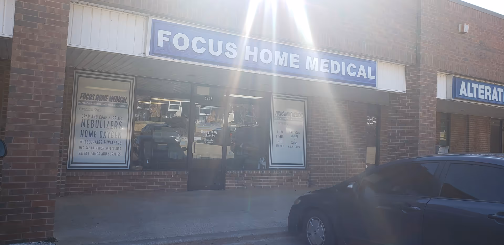 Brick storefront reading Focus Home Medical with a blue sign and a parked car outside