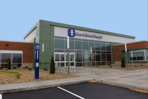 Facade of Akron Children's outpatient lab building with glass entrance and parking lot