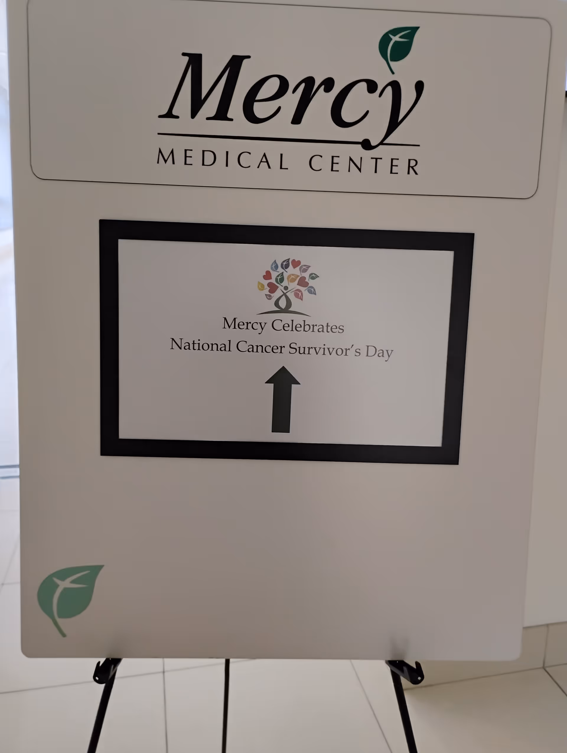 Interior display board showing Mercy Medical Center logo and Cancer Survivor's Day message