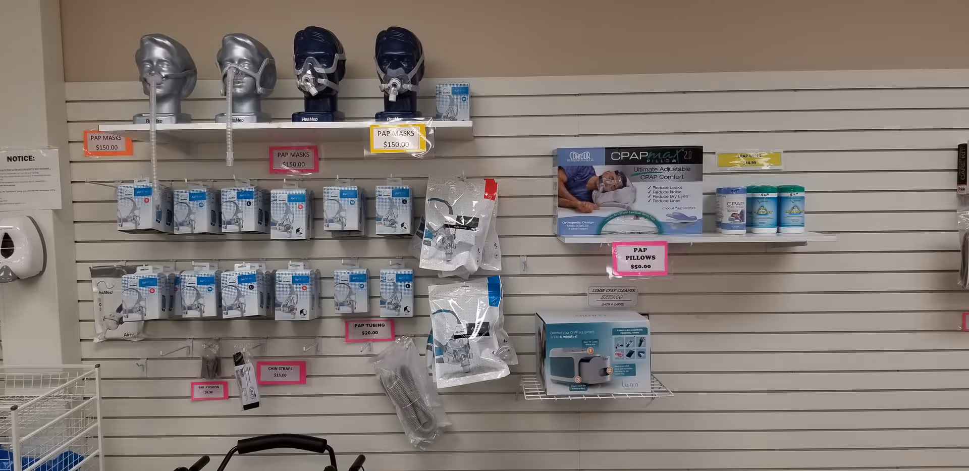 Shelves display CPAP machines, masks, and other medical supplies in an interior clinic area.