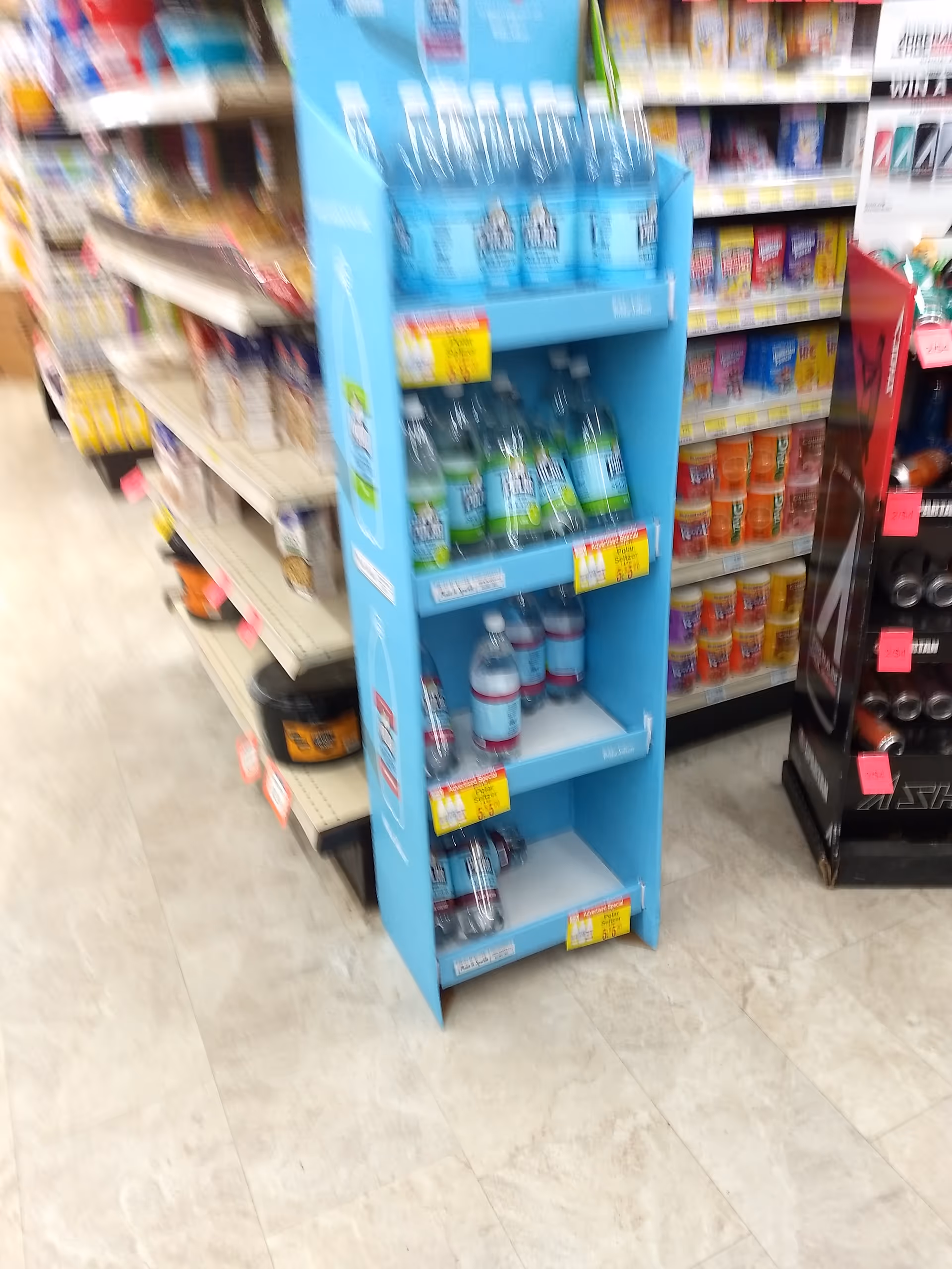 Blue beverage display shelf with assorted drinks in a store aisle