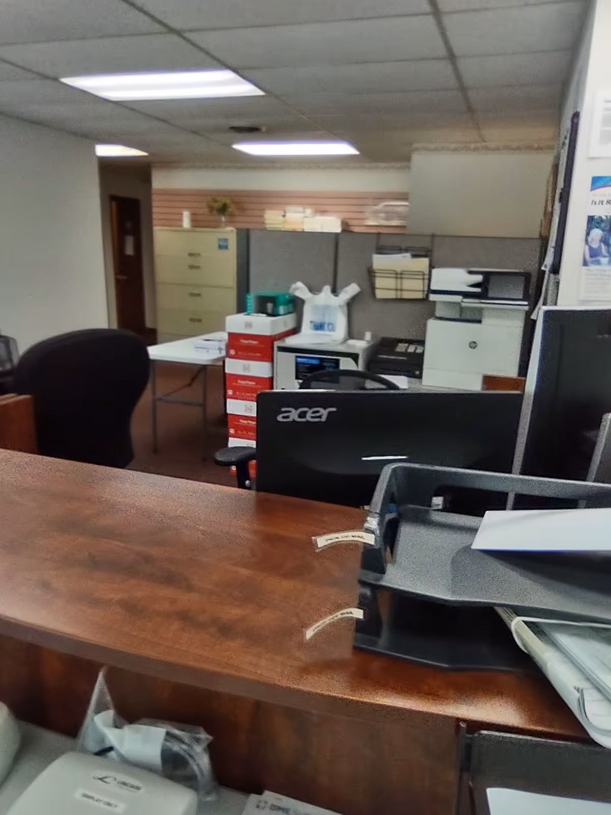 Office reception area with desk, computer monitor, and filing equipment inside LINCARE facility.