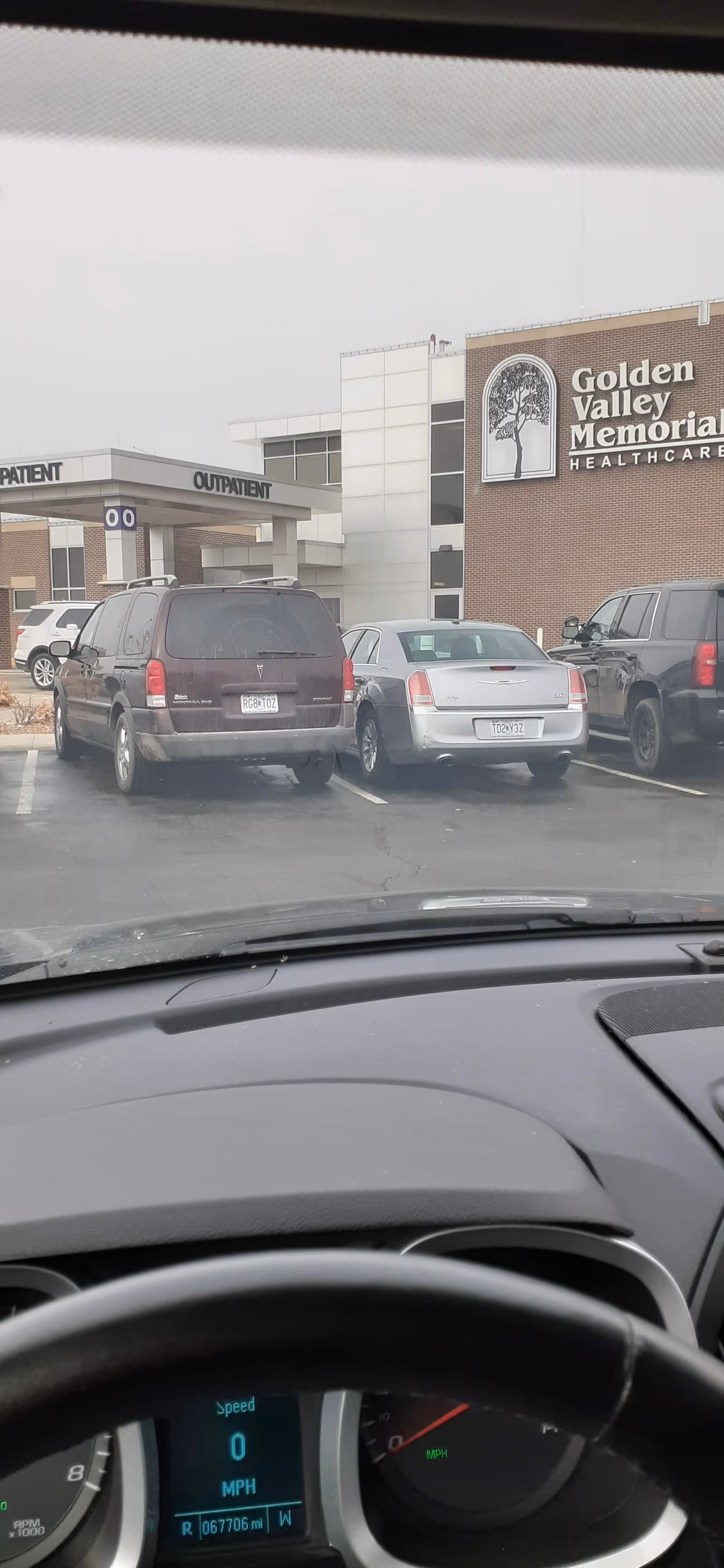 Exterior view of Golden Valley Memorial Healthcare with a parking lot and several cars.