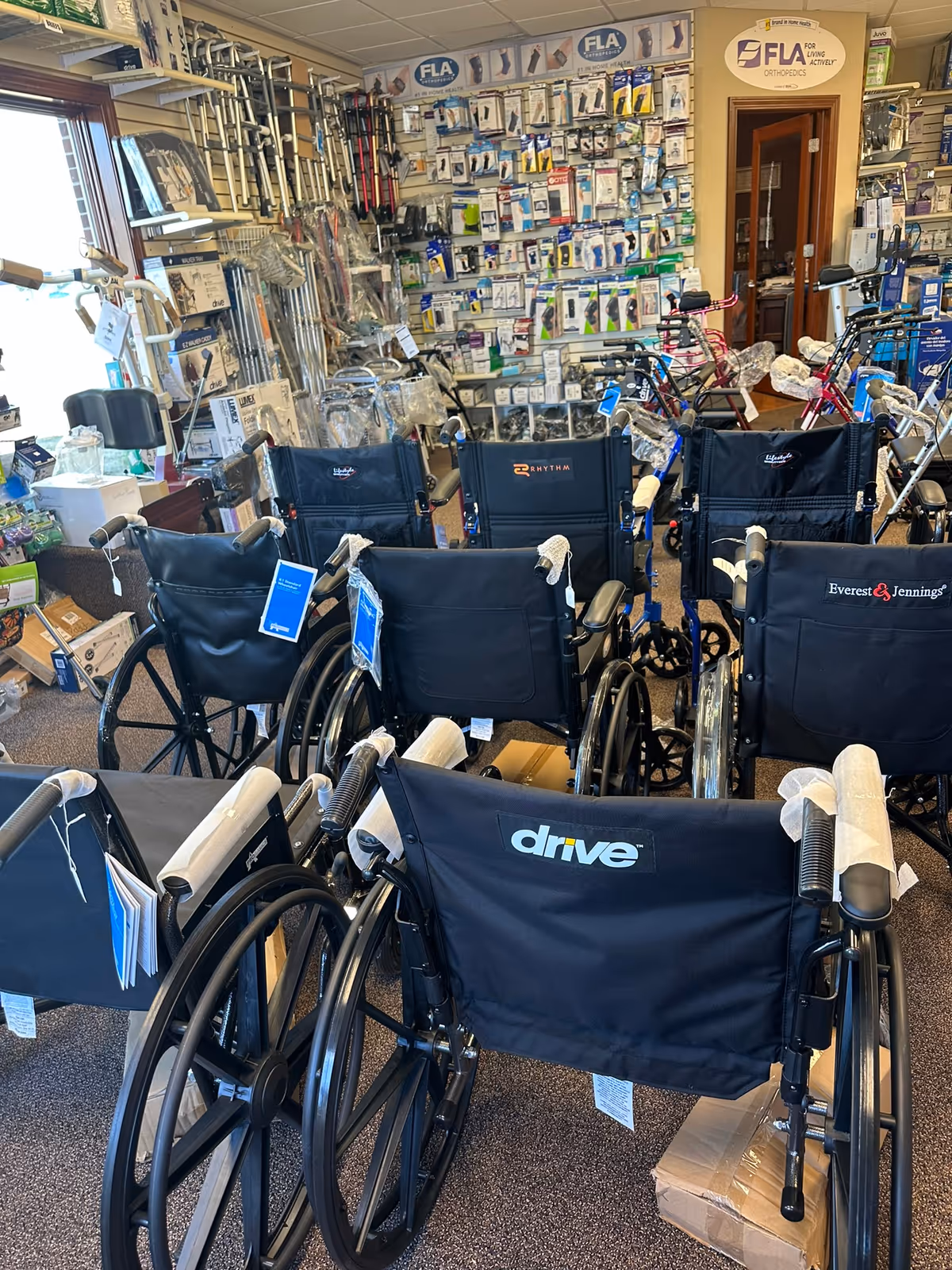 Interior showroom filled with wheelchairs and mobility aids on display.