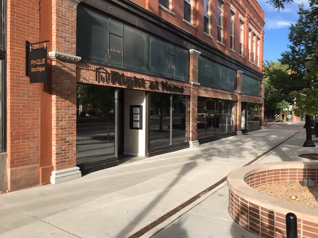 Brick exterior of a Right at Home facility with large storefront windows along the sidewalk.