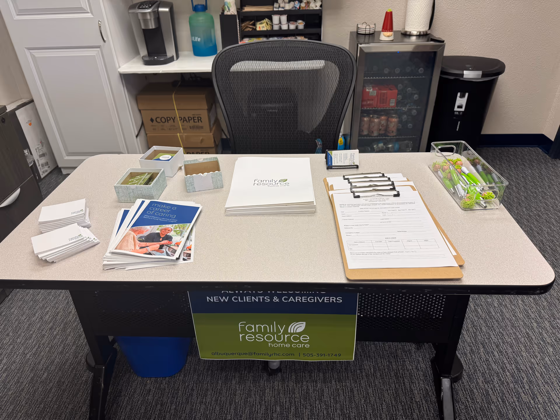 Reception desk with brochures, forms, and Family Resource Home Care signage in an office.