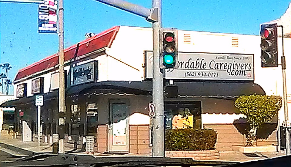 Exterior of Affordable Caregivers storefront on a street corner with traffic light.