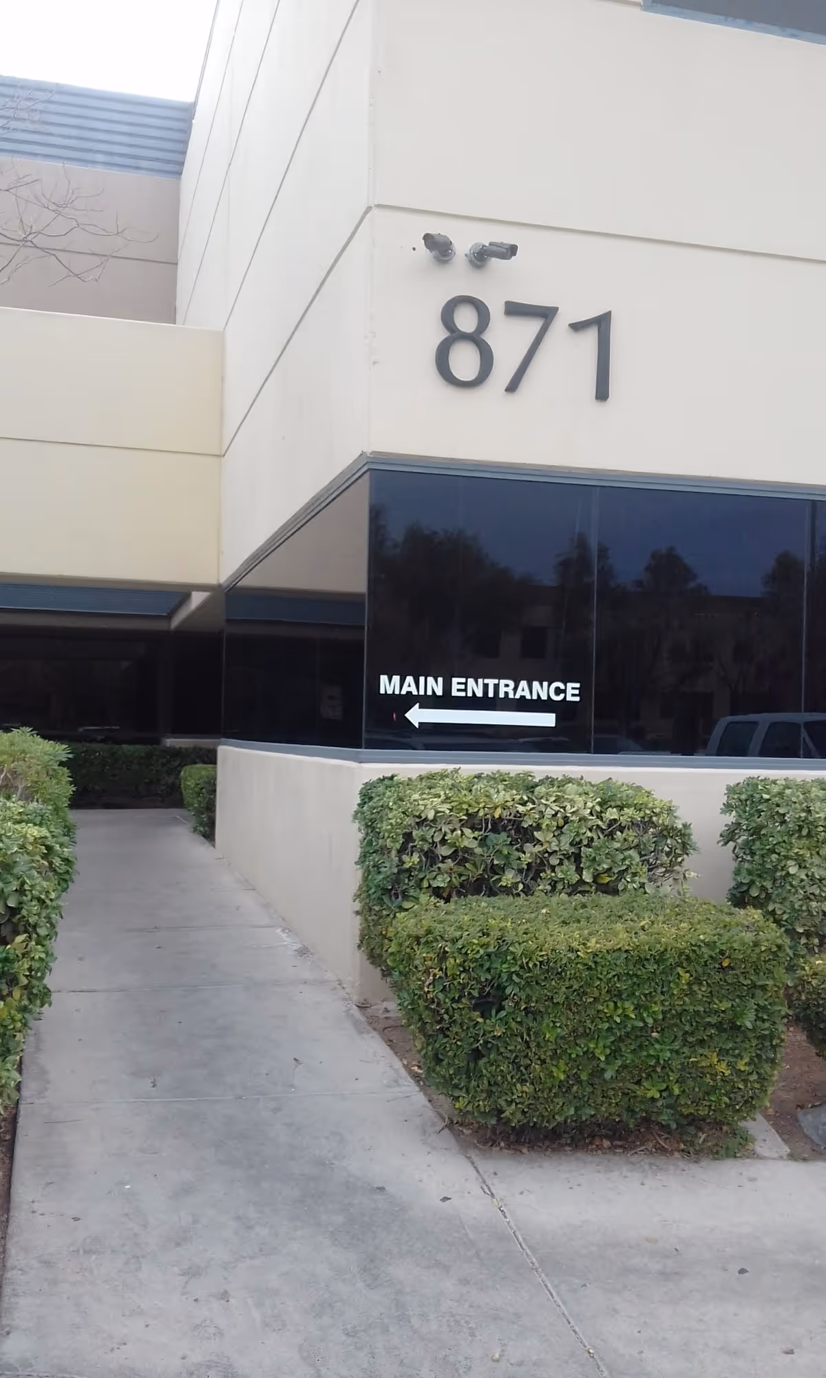 Exterior view of facility entrance with 871 address and main entrance sign