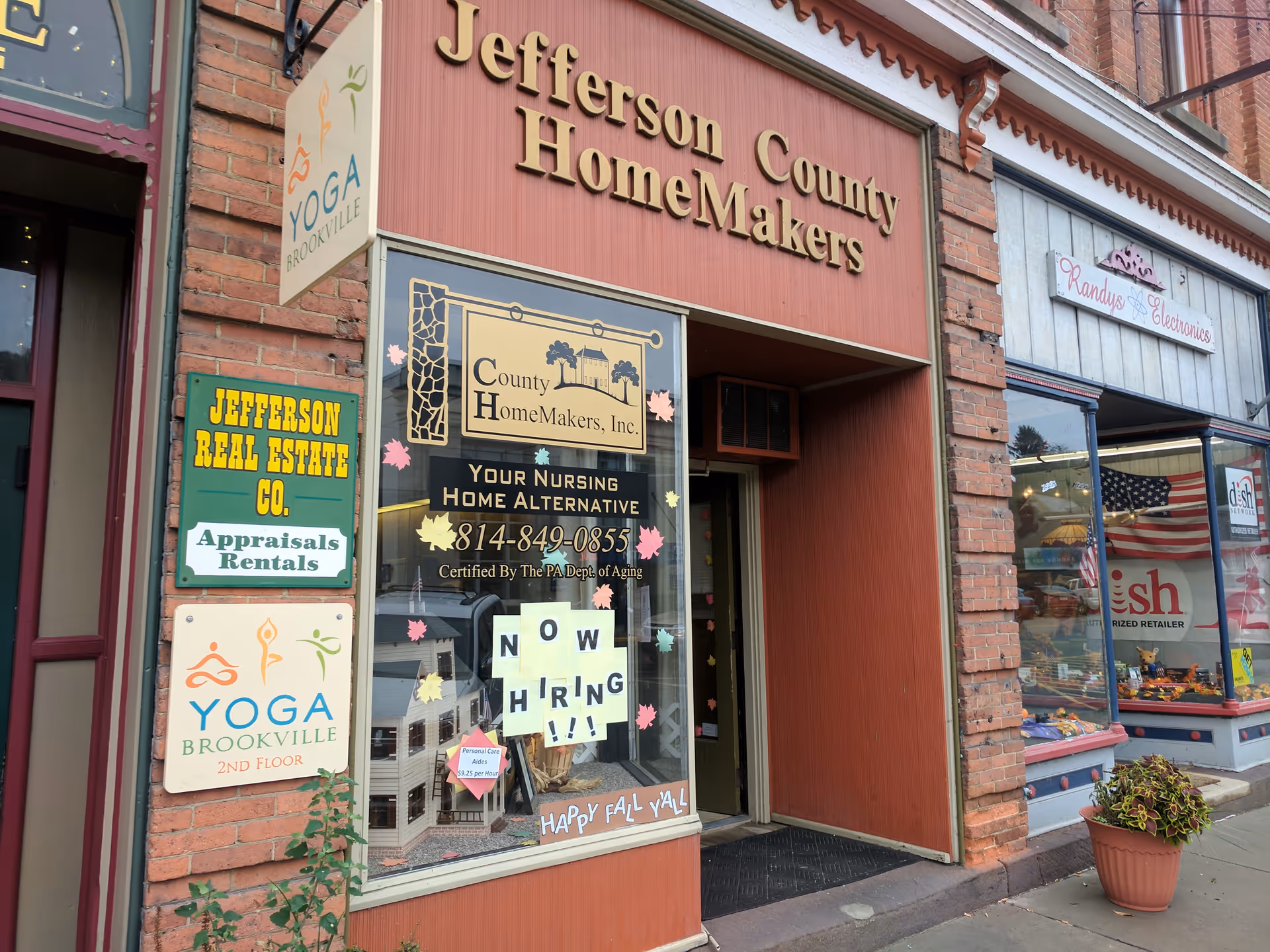 Street storefronts featuring Jefferson County HomeMakers and nursing home signage on a brick building.