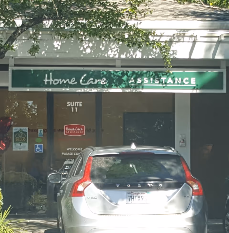 Exterior storefront of Home Care Assistance with a car parked in front.