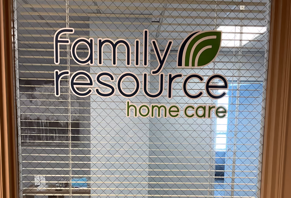 Glass door with wire mesh displaying Family Resource Home Care logo and text.
