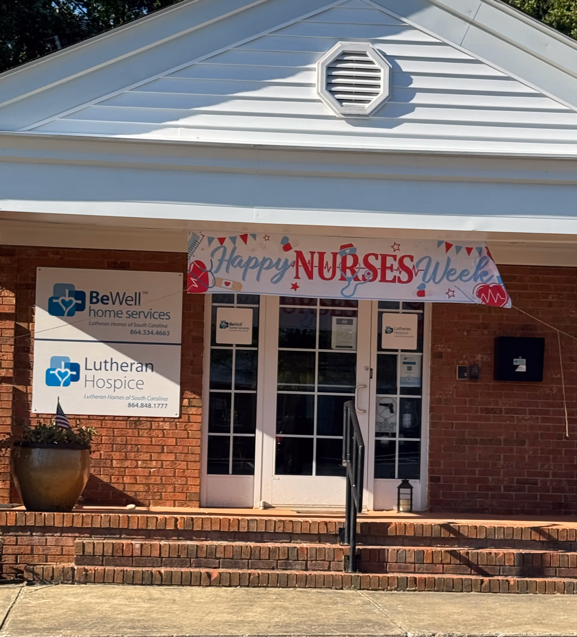 Front entrance of BeWell Home Services with a Happy Nurses Week banner.