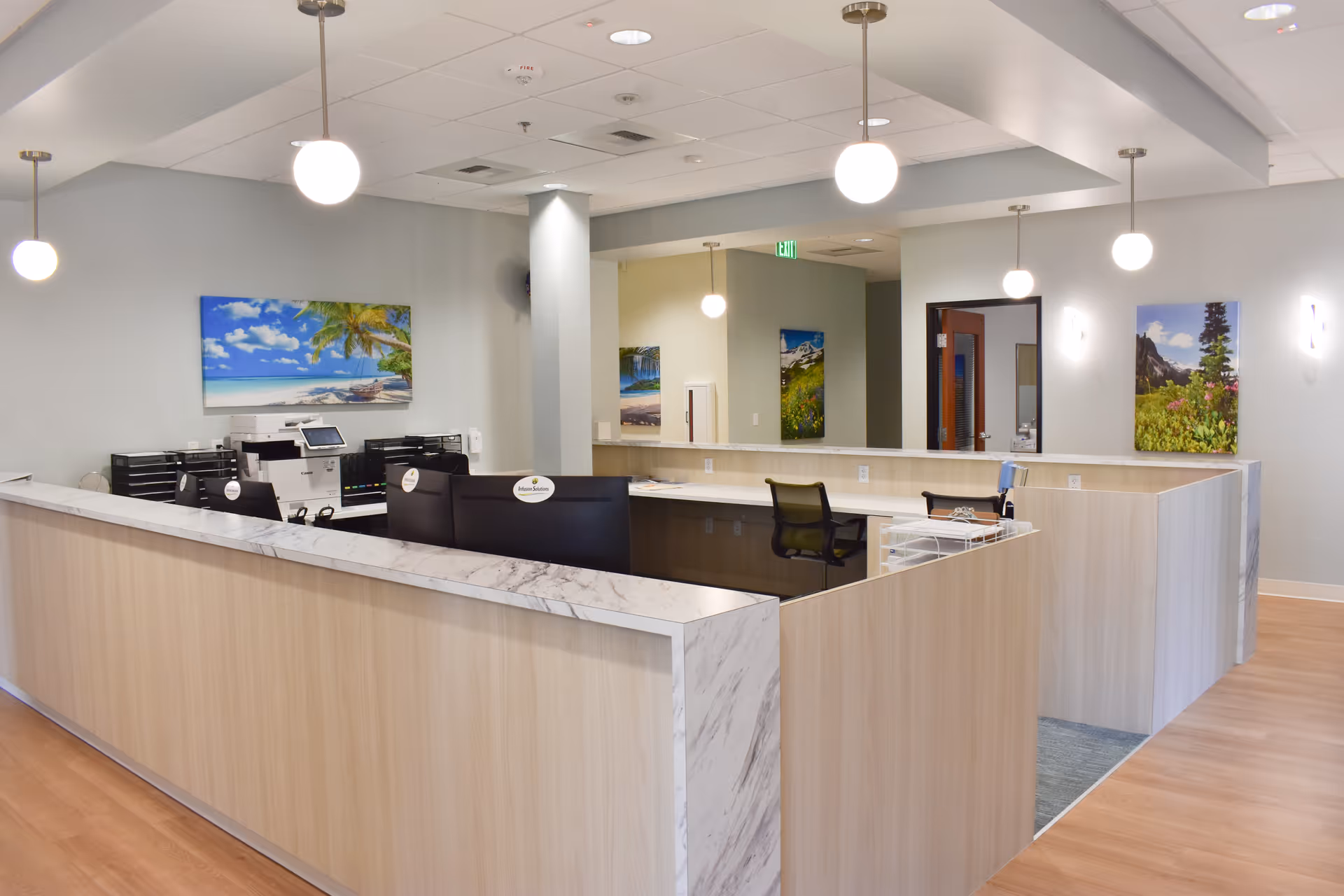 Modern reception desk with marble counters in a bright senior living facility lobby.