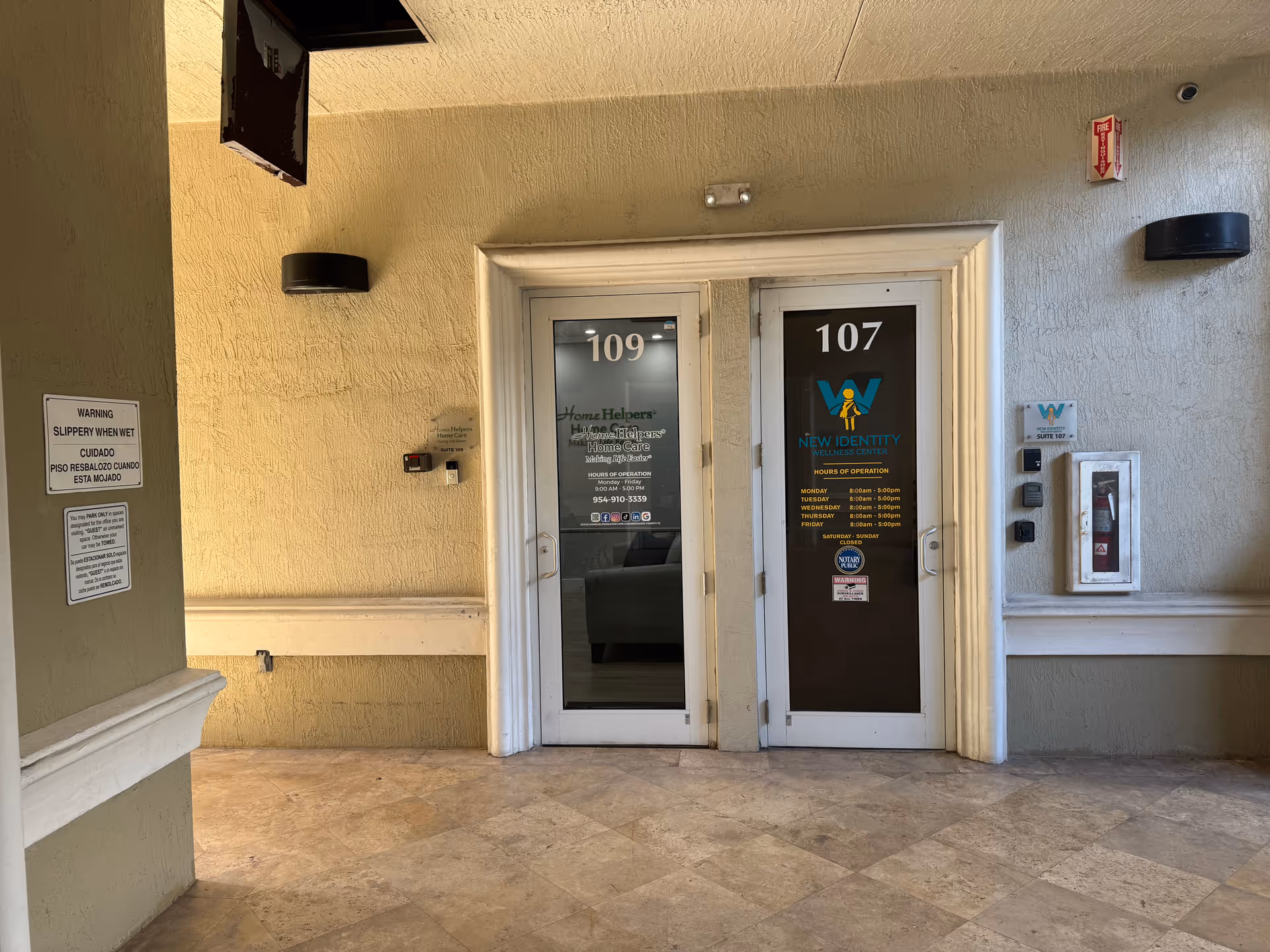 Interior hallway with two doors labeled 109 and 107 at a senior care facility entrance