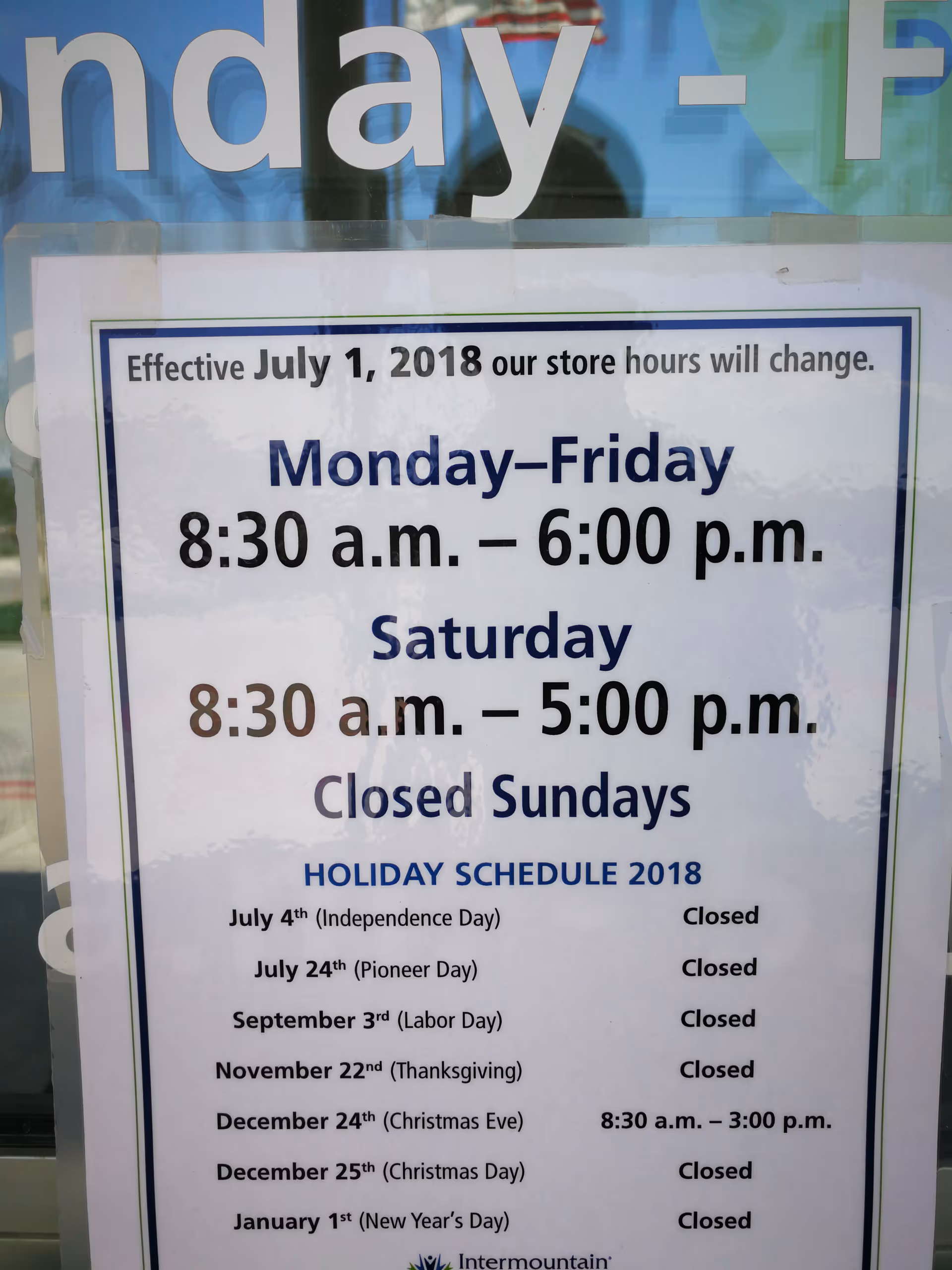 Storefront window sign displaying weekly hours and holiday schedule for the facility.