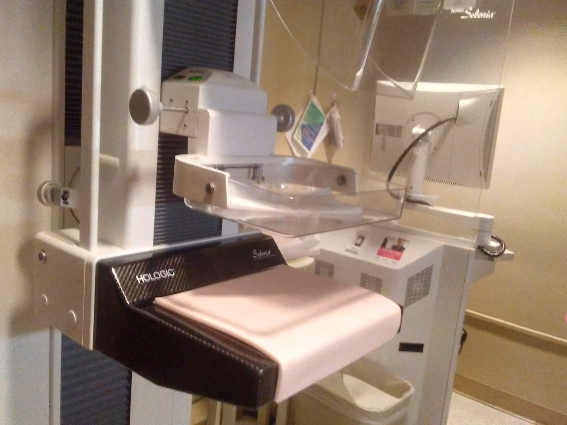 Mammography machine with patient table in a radiology imaging room.