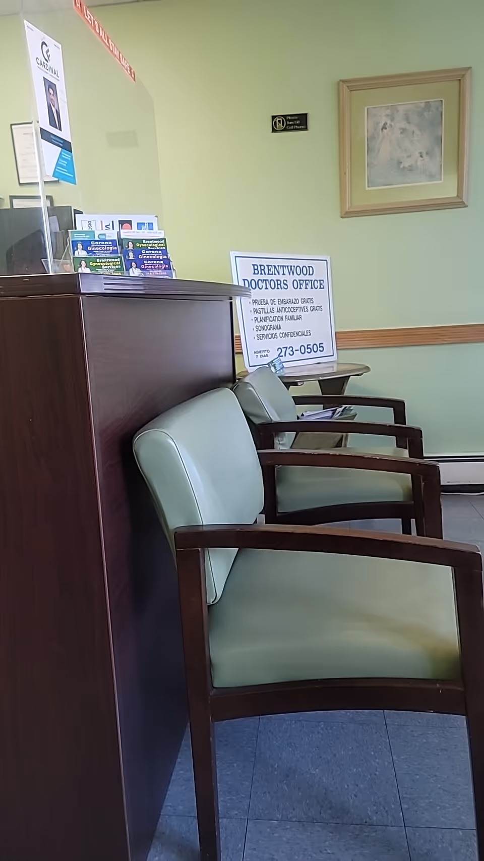 Interior waiting area with green cushioned chairs and Brentwood Doctors Office signage.