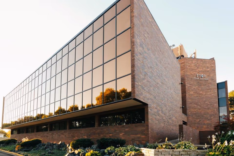 Exterior view of Access Day Support Services Center with brick and glass facade.