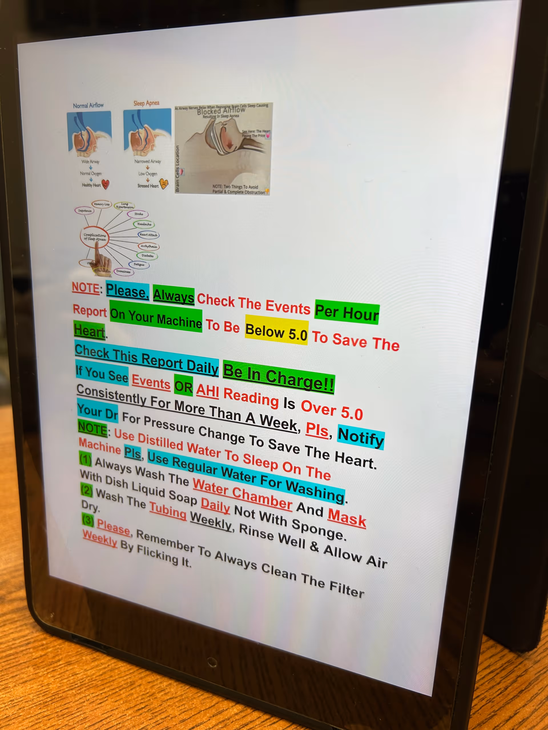 Tablet screen displaying a highlighted document with small diagrams, resting on a wooden surface.