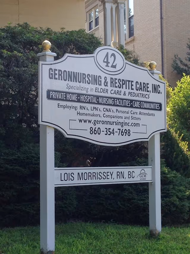 A white outdoor sign for Geron Nursing & Respite Care, Inc., with contact information.