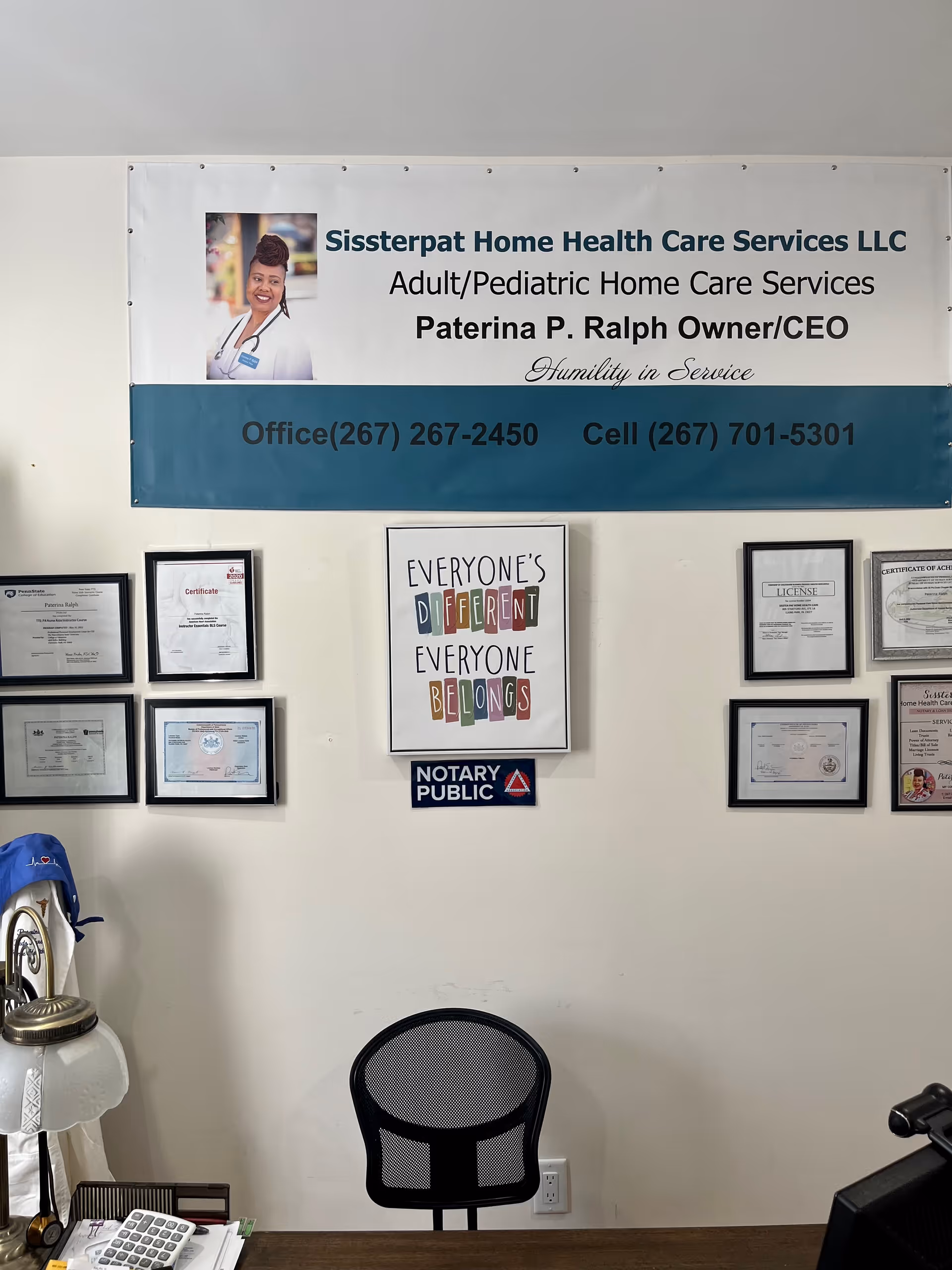 Reception area featuring a banner for Sissterpat Home Health Care Services LLC and framed certificates.