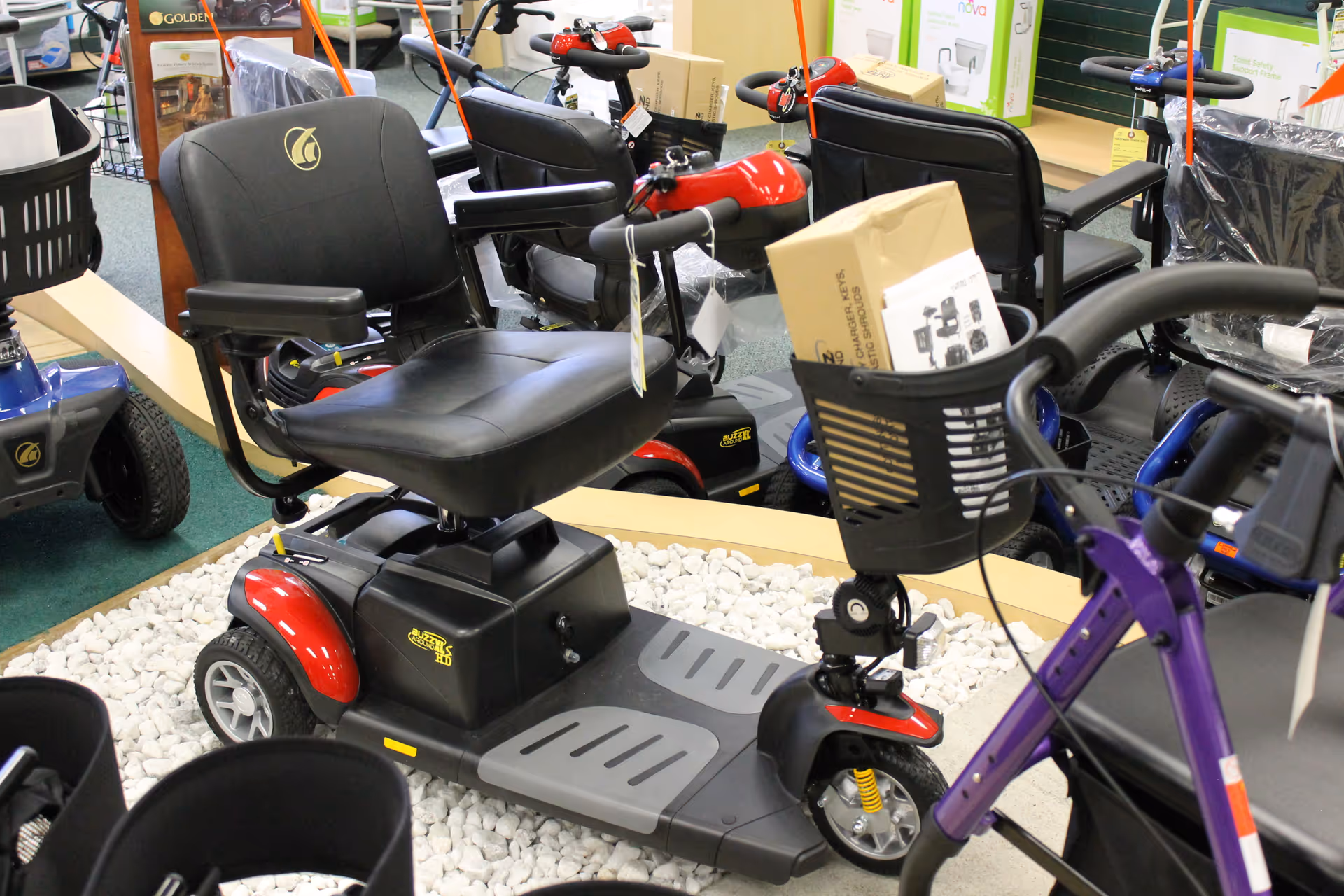 Indoor display of mobility scooters and medical equipment in a showroom.