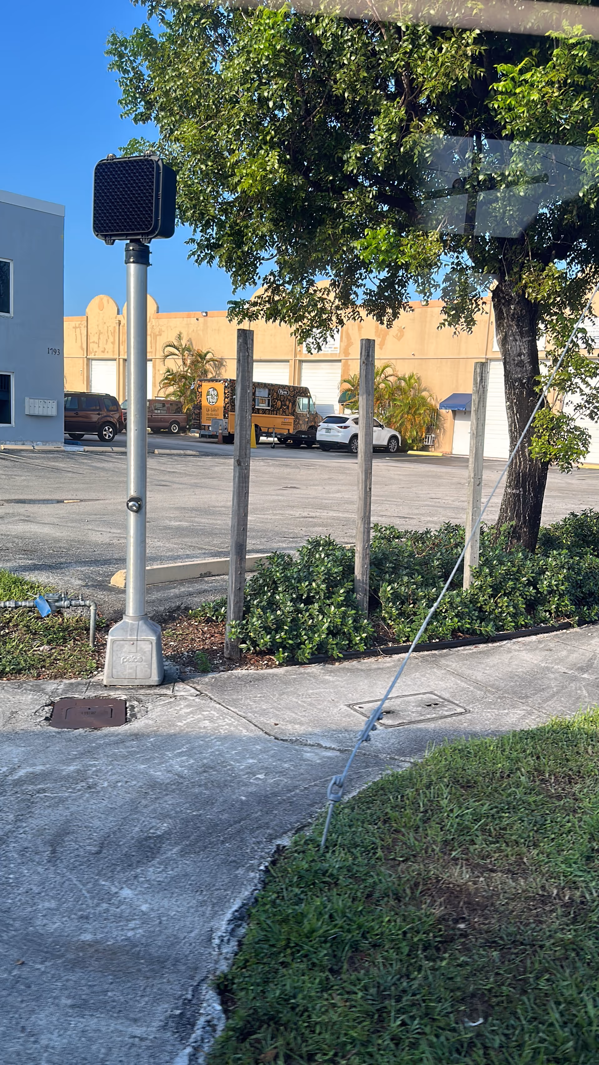 Outdoor view of a sidewalk and parking lot in front of Versalles Home Health Medical building.