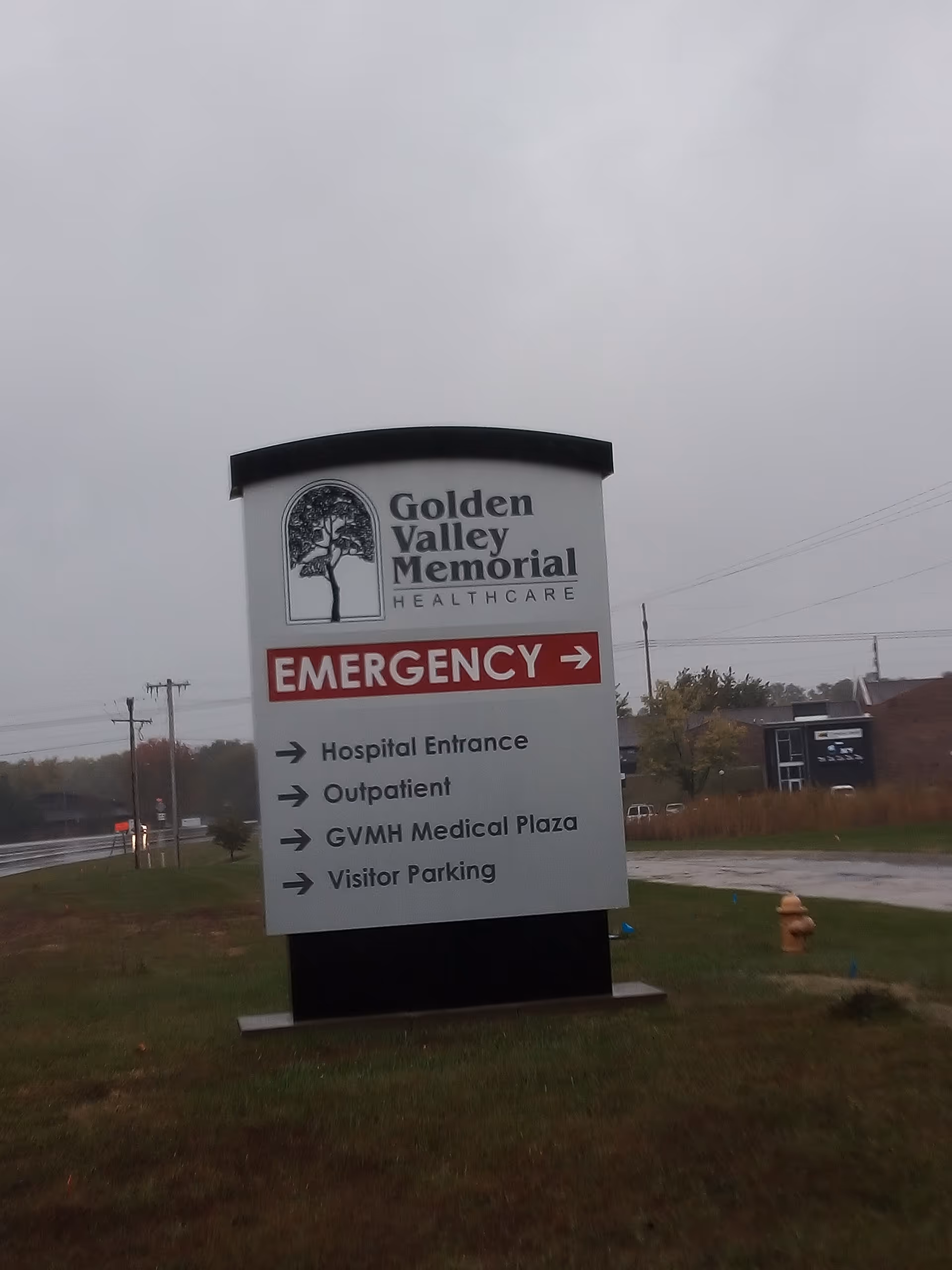 Large outdoor hospital sign for Golden Valley Memorial Healthcare with emergency directions.
