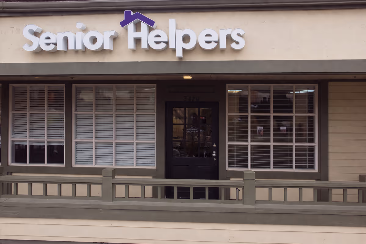 Front exterior of a Senior Helpers facility with sign and windows.