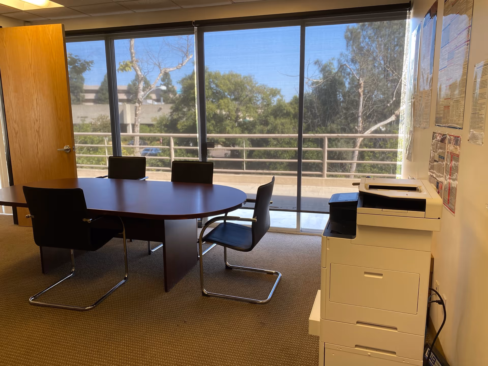 Office-style conference room at Aspire Home Healthcare with round table and large windows.