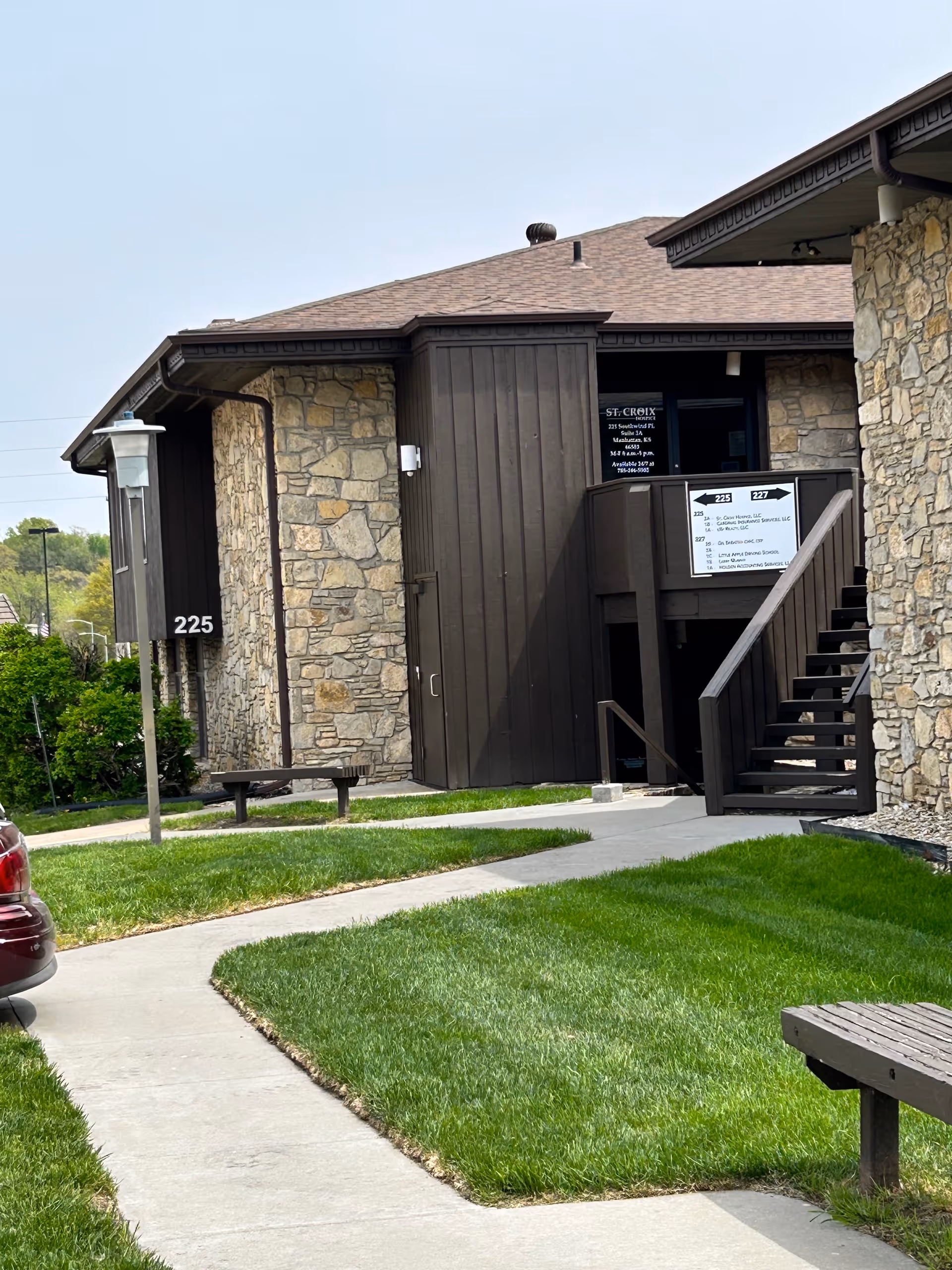 Exterior view of a St. Croix Hospice building with stone walls and stairs.