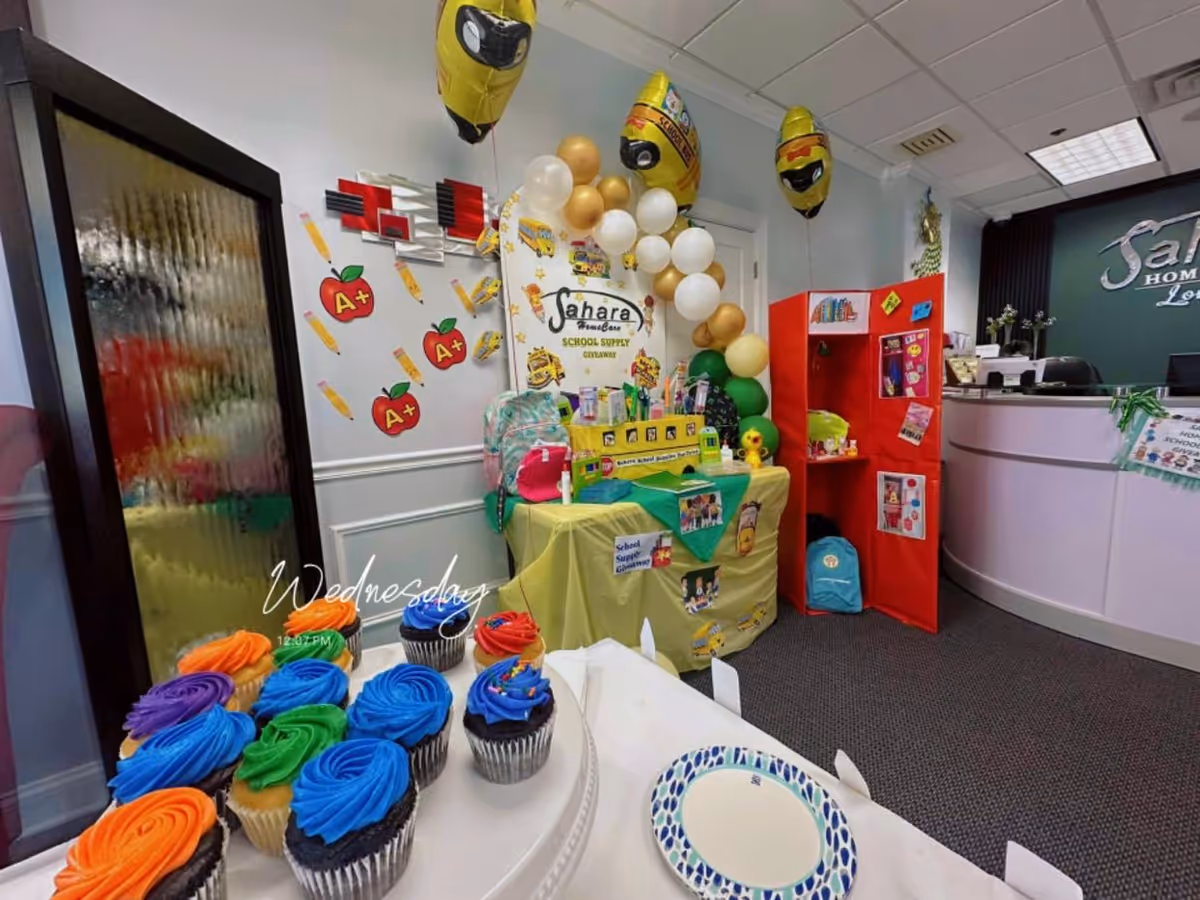 Interior lobby at Sahara Home Care with balloons, cupcakes, and a promotional display.
