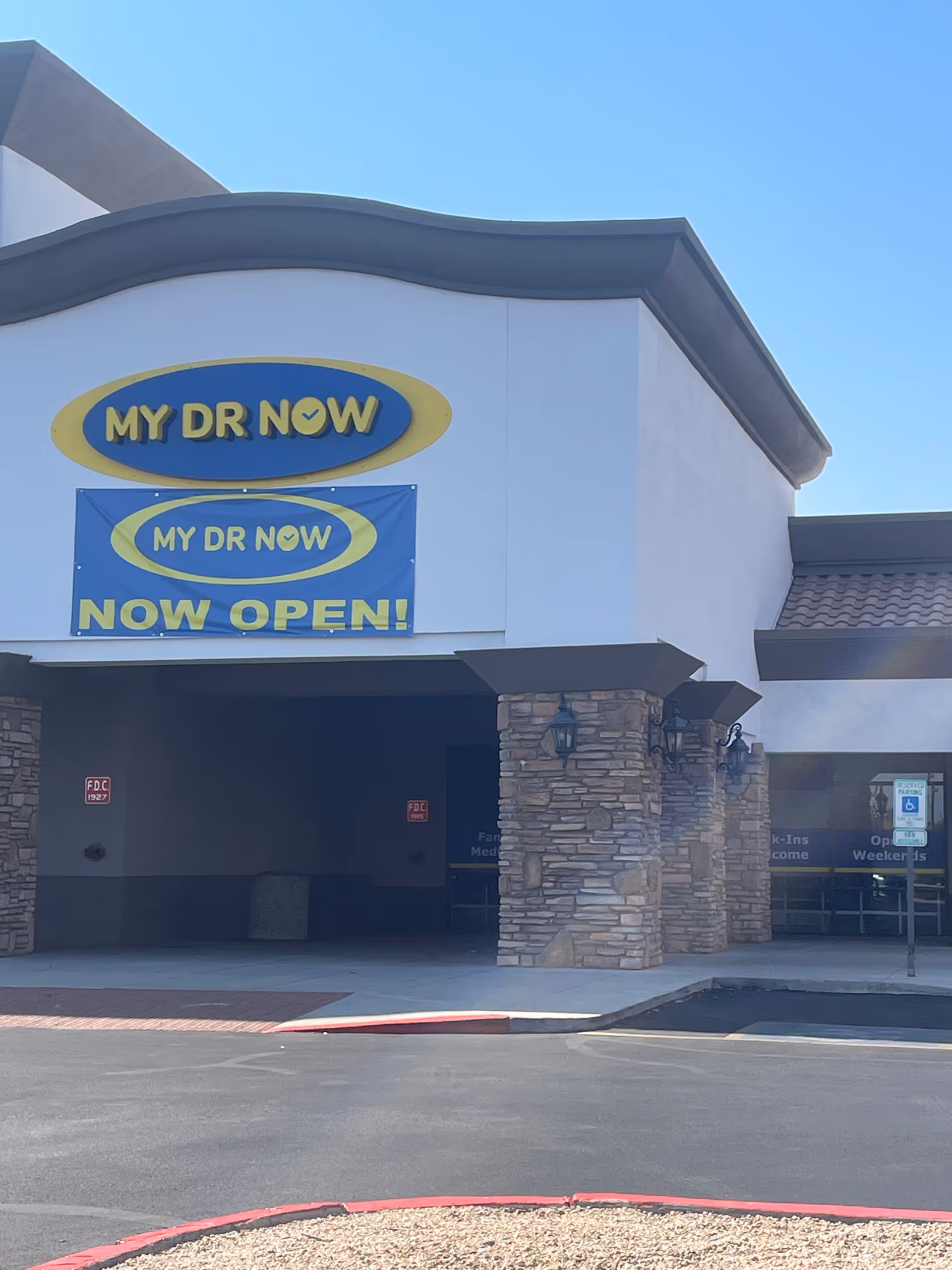 Front exterior of a My Dr Now facility with a Now Open banner