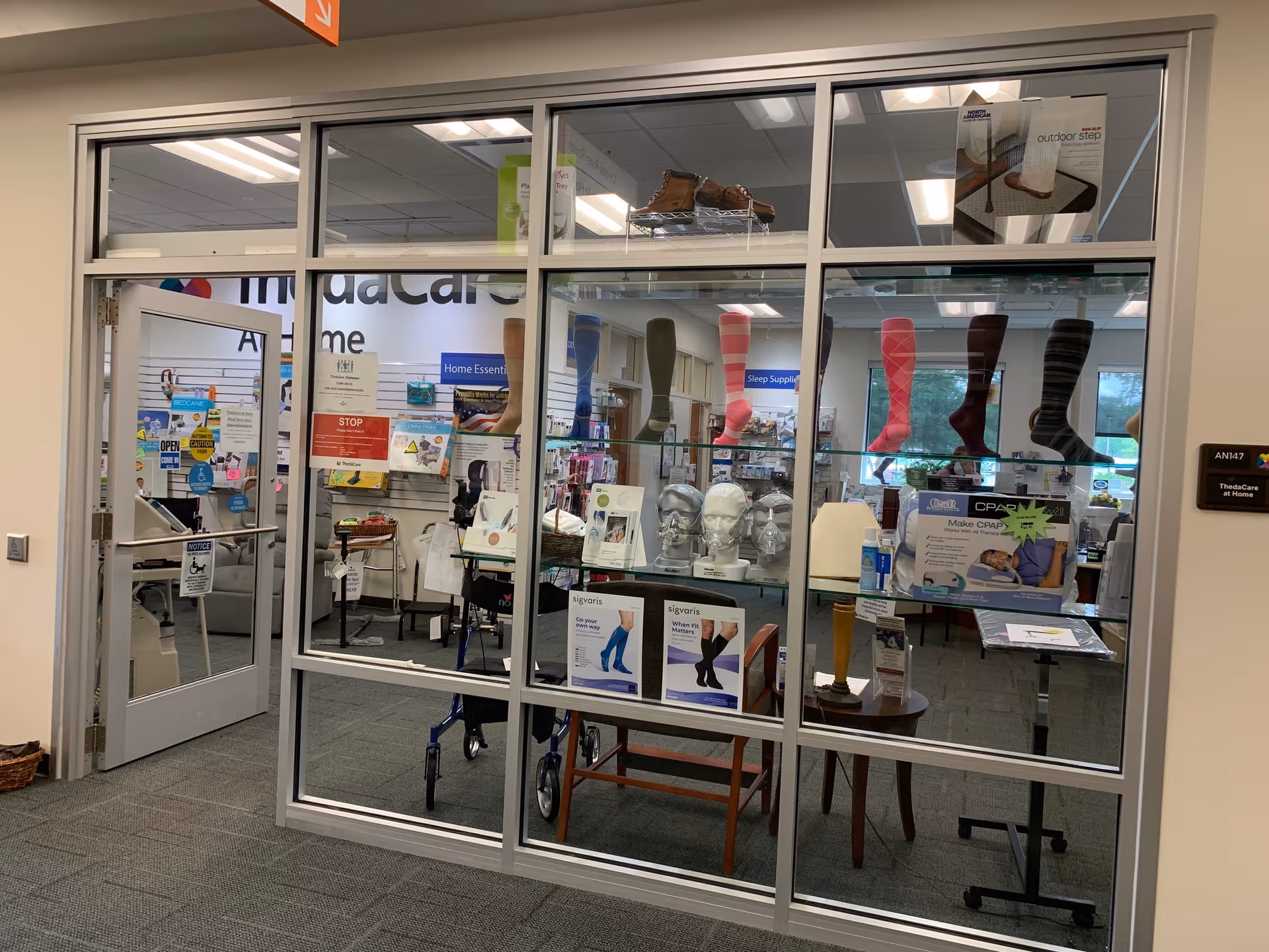 Interior showroom of ThedaCare At Home-Waupaca, showcasing medical equipment behind glass walls.