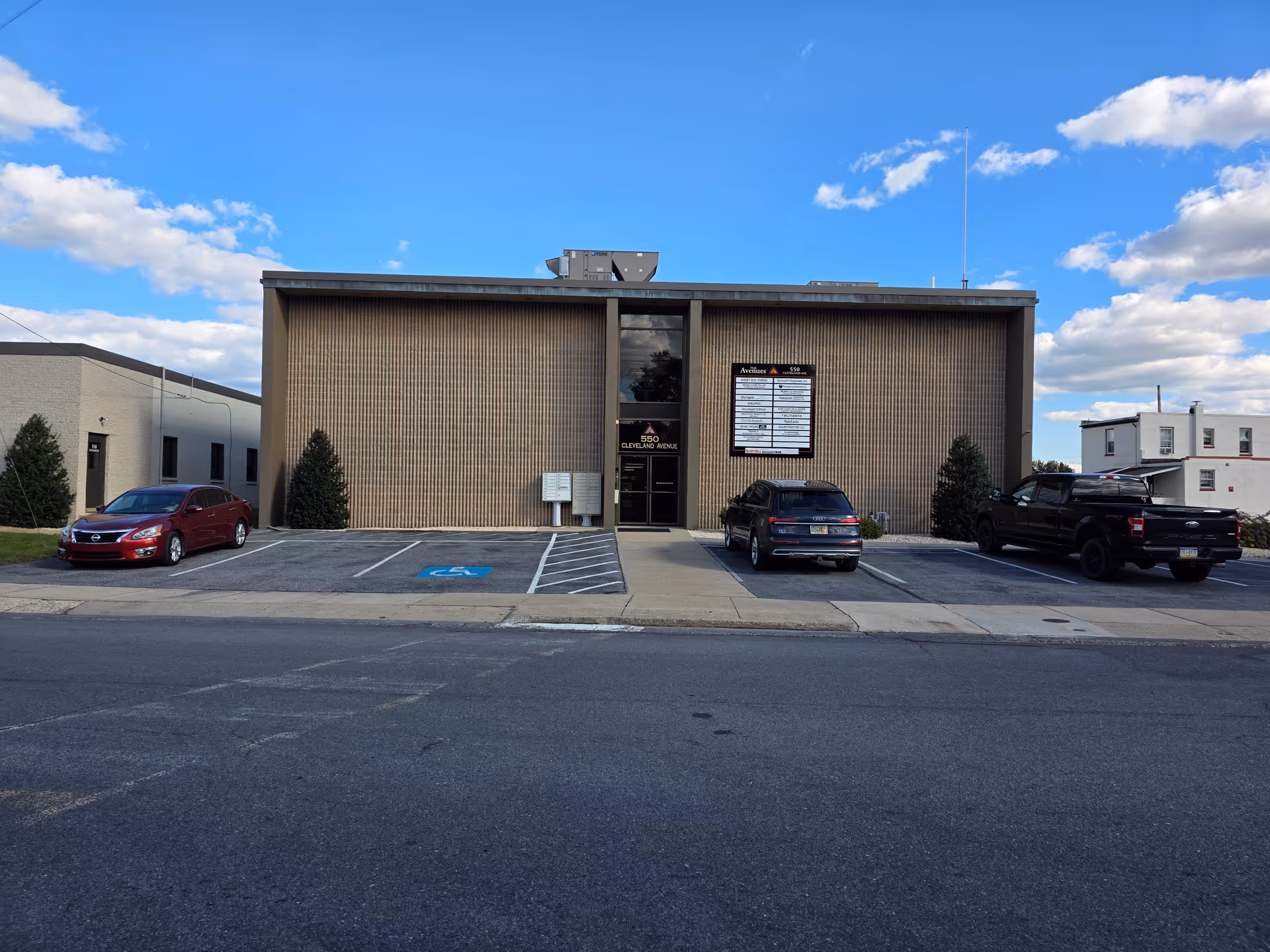 Front view of Visiting Angels Senior Home Care building with a parking lot.
