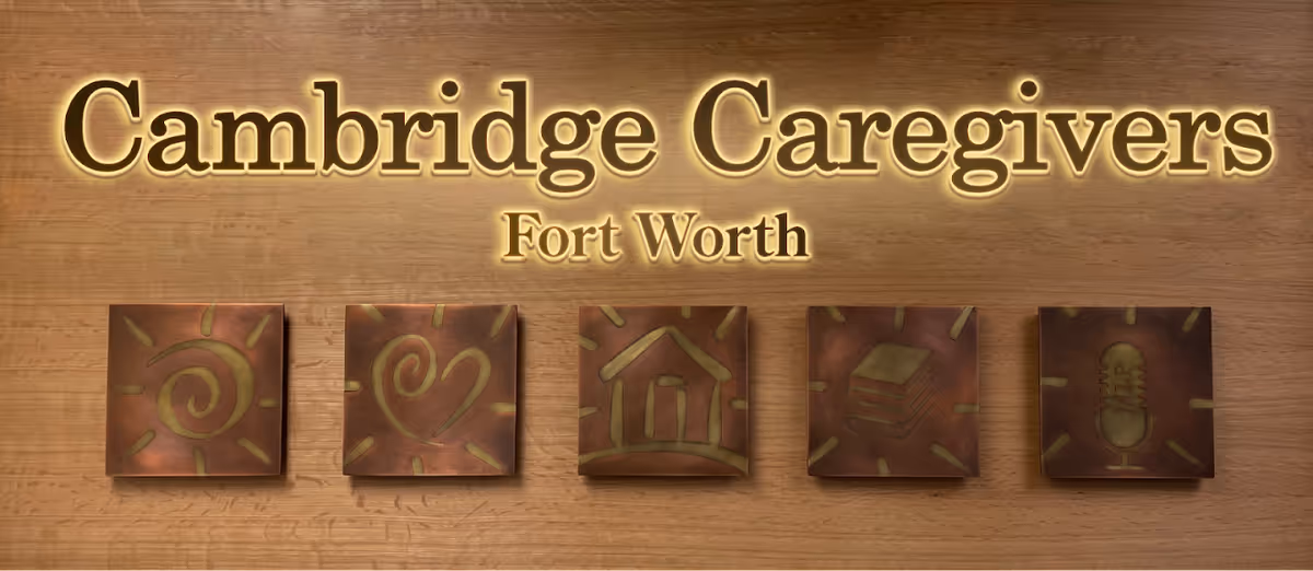 Interior wall featuring Cambridge Caregivers Fort Worth sign with five decorative square tiles.