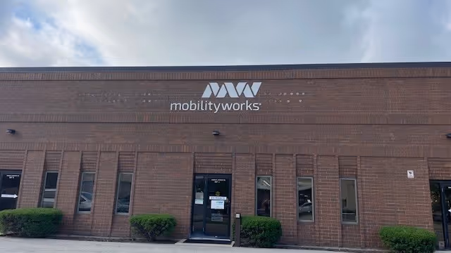 Exterior view of MobilityWorks facility with brick facade and entrance signage.