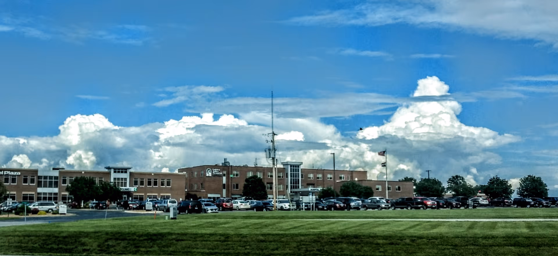Exterior view of Golden Valley Memorial Healthcare building with parking lot and blue sky.