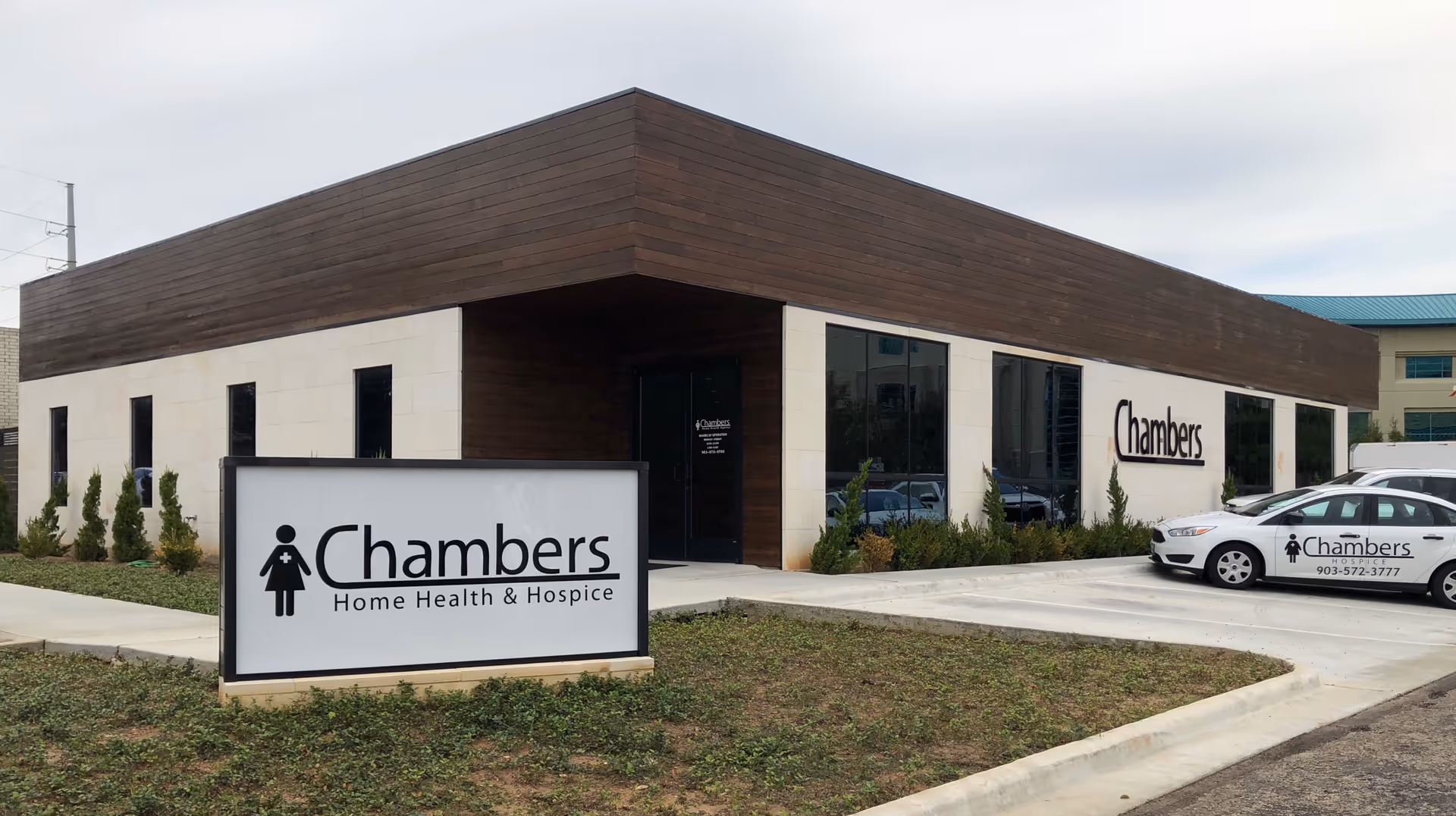 Modern single-story medical facility exterior with Chambers Home Health & Hospice sign.