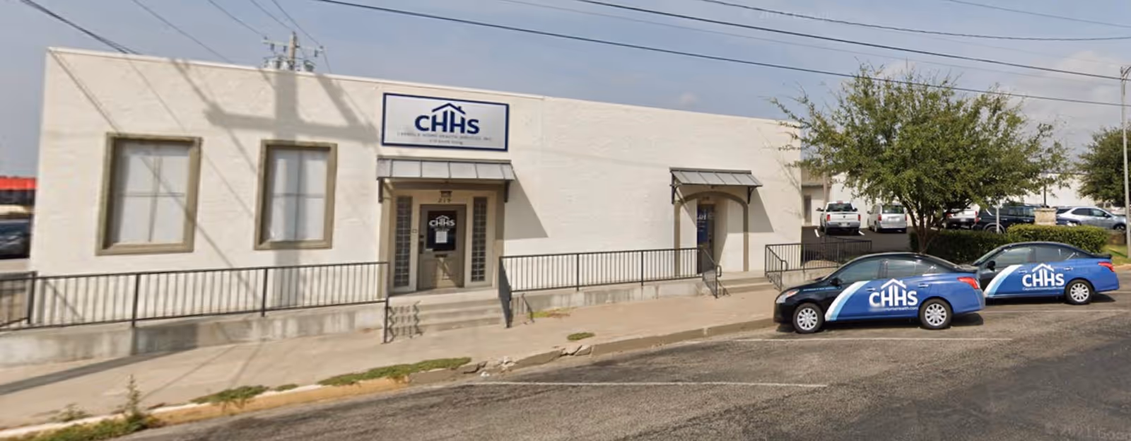 Front view of Caprock Home Health Services Inc building with two CHHS cars outside