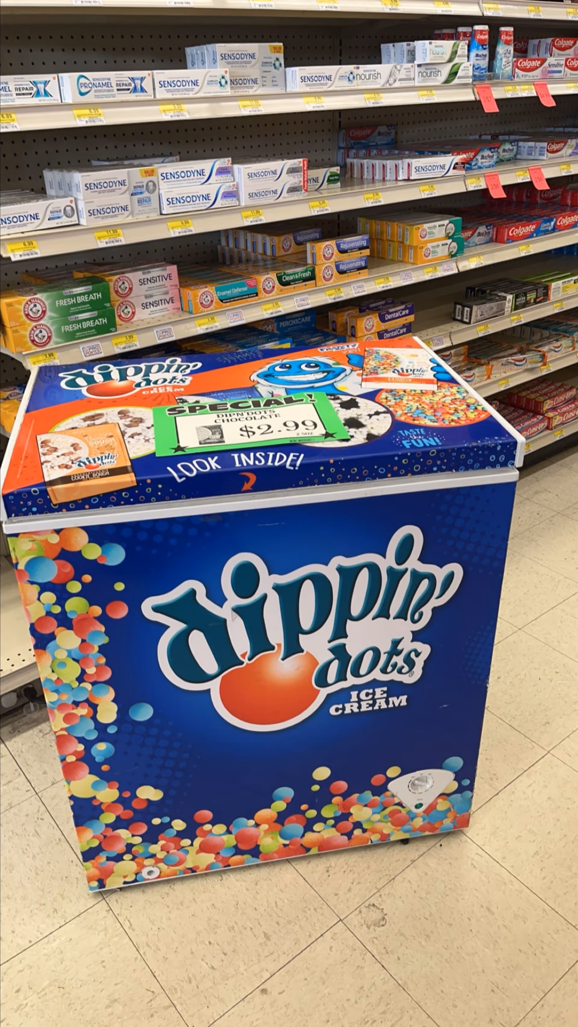 Blue Dippin' Dots ice cream freezer in a Discount Drug Mart aisle