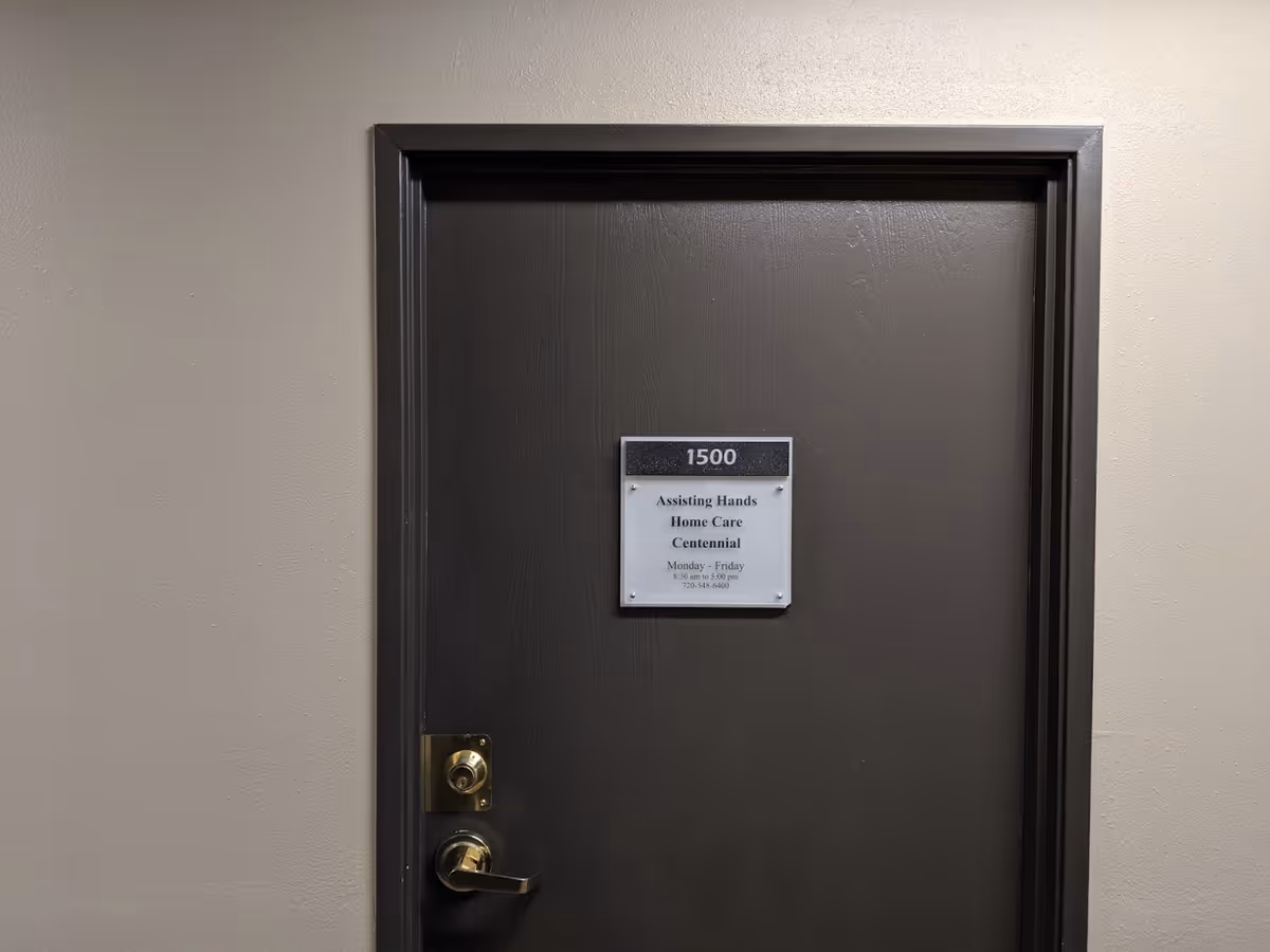 Dark interior door with plaque reading 1500 in a hallway.