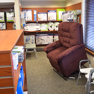 Brown recliner chair in a medical equipment showroom with CPAP supplies on shelves