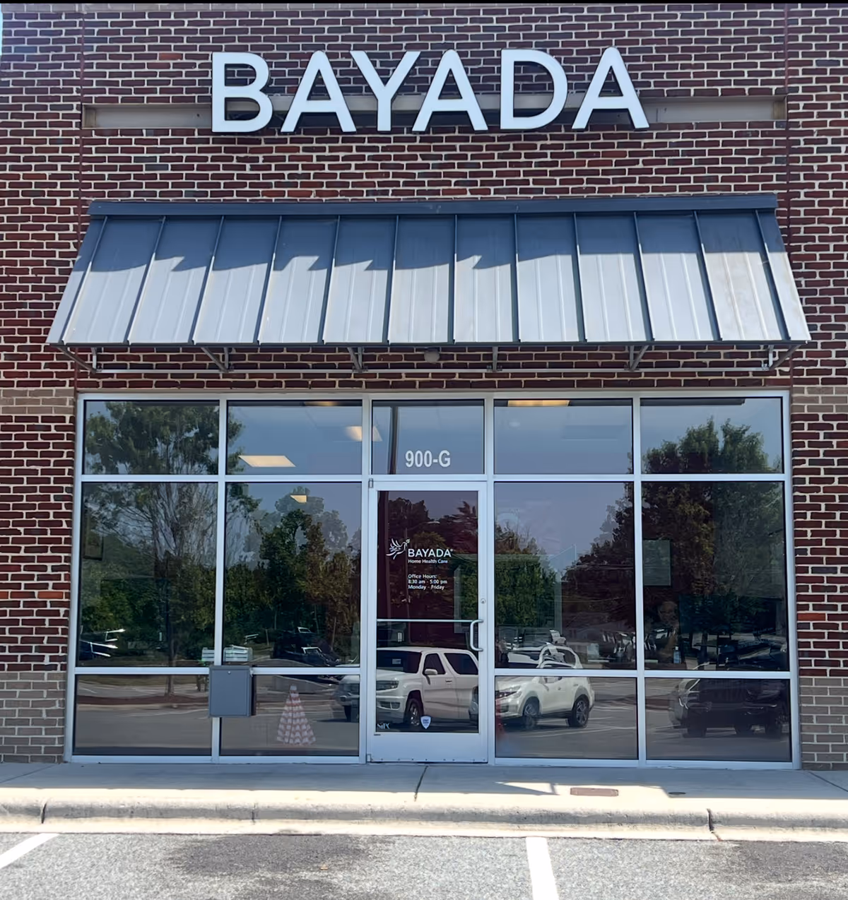 Brick exterior of BAYADA Home Health with glass entrance doors and a metal awning.