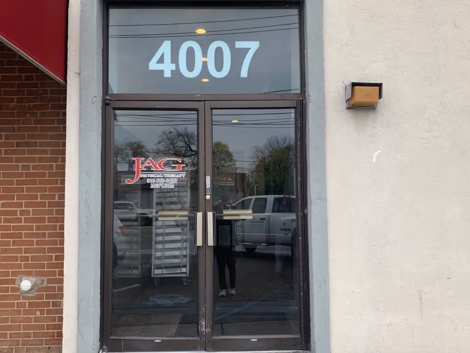 Front entrance of a building with the number 4007 and JAG Physical Therapy logo.