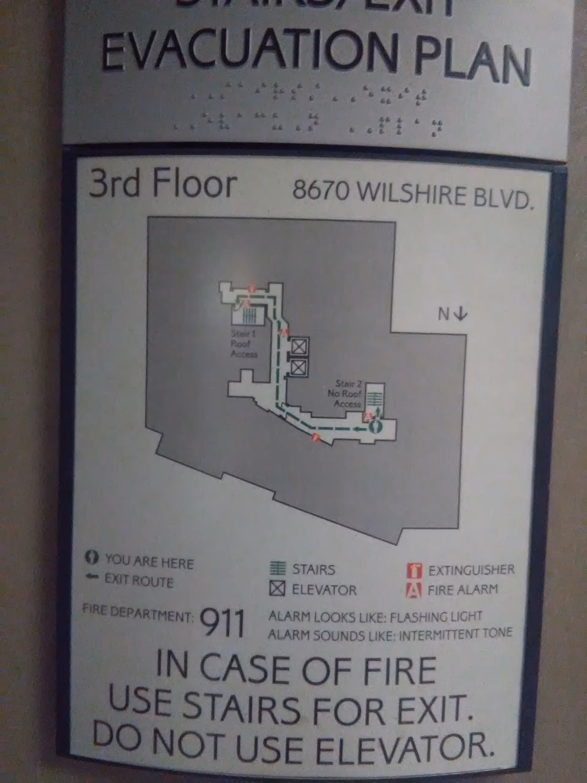 Indoor evacuation plan sign showing floor layout and exit routes.