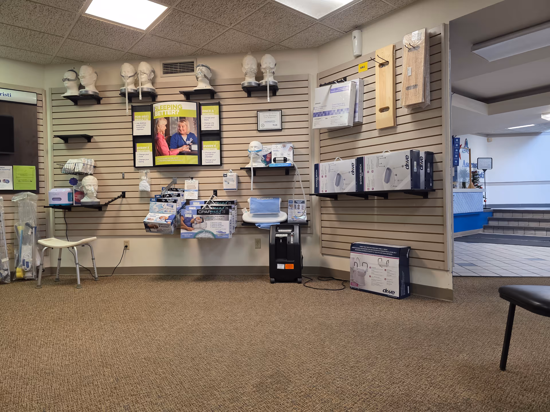 Indoor medical supply showroom with mannequin heads, CPAP boxes, and display shelves.